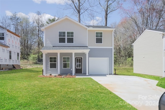 view of property featuring a garage and a front yard