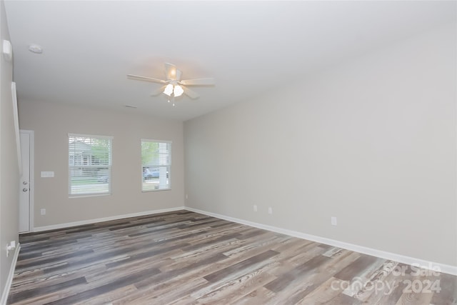 spare room with hardwood / wood-style floors and ceiling fan