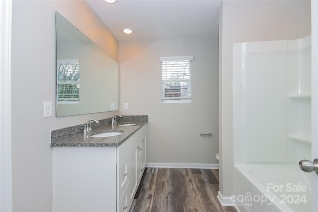 bathroom featuring hardwood / wood-style floors, vanity, and toilet