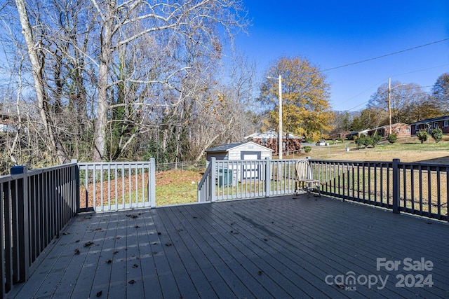 wooden terrace featuring a shed