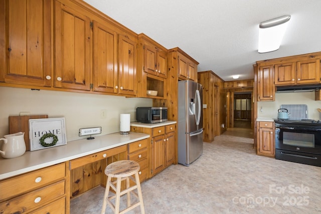 kitchen featuring a textured ceiling and appliances with stainless steel finishes