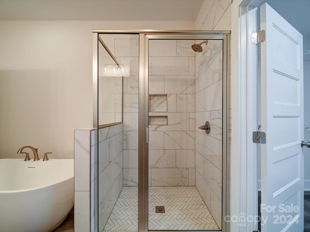 bathroom featuring separate shower and tub