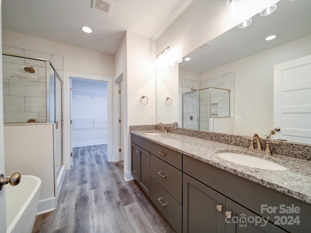 bathroom with separate shower and tub, vanity, and wood-type flooring