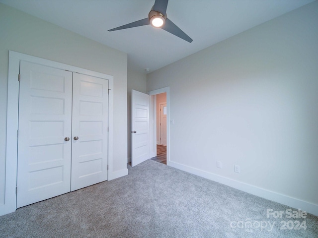 unfurnished bedroom with carpet flooring, a closet, and ceiling fan