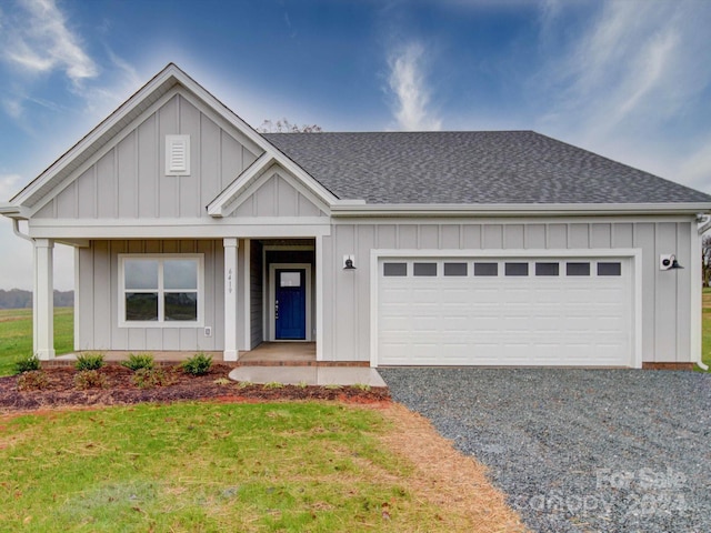 view of front facade featuring a front yard and a garage