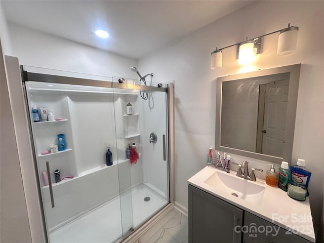 bathroom with vanity and a shower with shower door