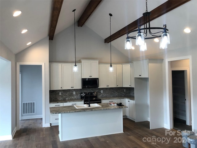 kitchen featuring white cabinetry, stainless steel appliances, an island with sink, and dark wood-type flooring