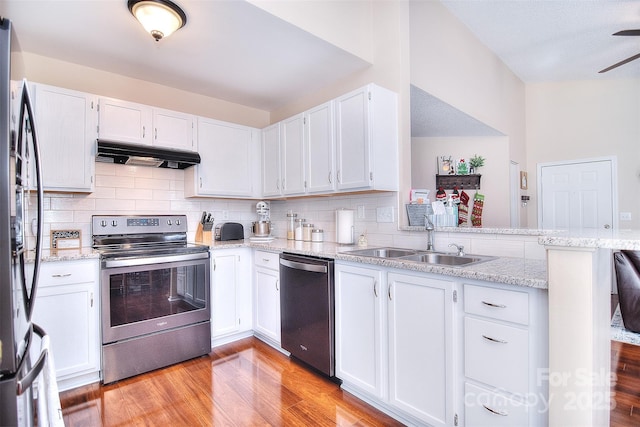 3076 Champion Ln SW, Concord, NC 28025 - kitchen with appliances with stainless steel finishes, under cabinet range hood, light wood-type flooring, a peninsula, and white cabinets