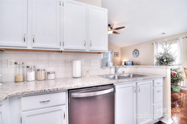 3076 Champion Ln SW, Concord, NC 28025 - kitchen with dishwasher, white cabinets, lofted ceiling, decorative backsplash, and ceiling fan