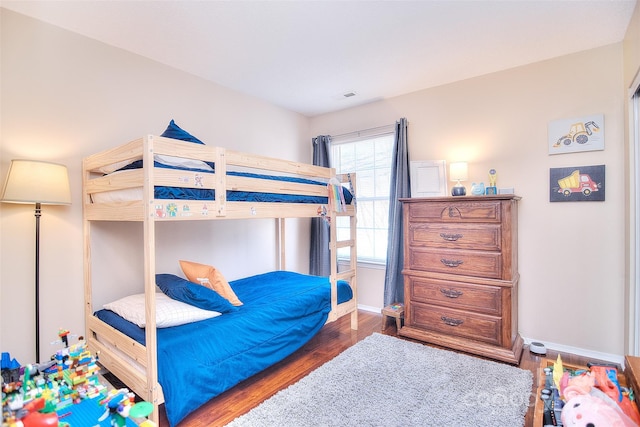 3076 Champion Ln SW, Concord, NC 28025 - bedroom featuring baseboards and wood finished floors