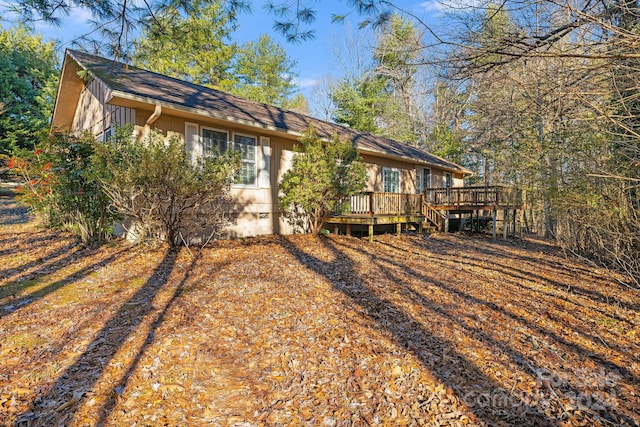 rear view of house featuring a deck