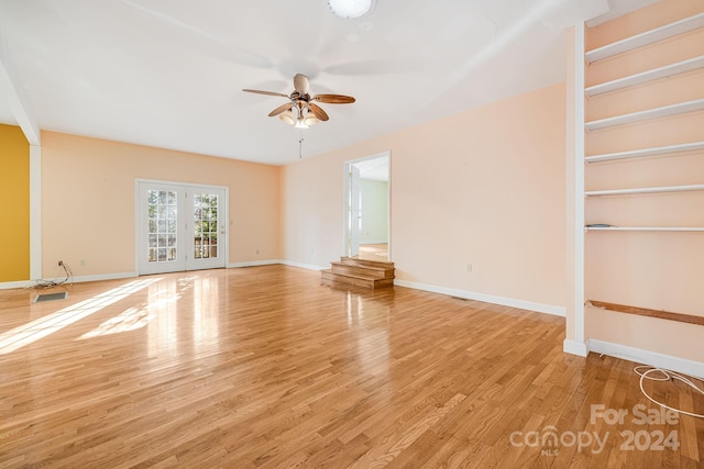 unfurnished living room featuring ceiling fan and light hardwood / wood-style floors