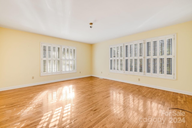 unfurnished room with light hardwood / wood-style floors