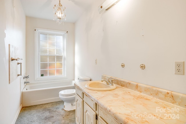 bathroom with a tub to relax in, vanity, a chandelier, and toilet