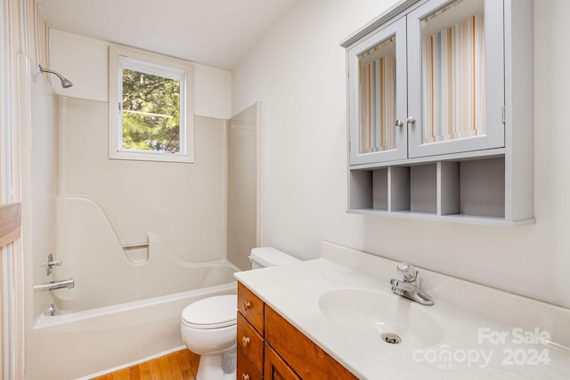 full bathroom featuring wood-type flooring, vanity, toilet, and shower / bathtub combination