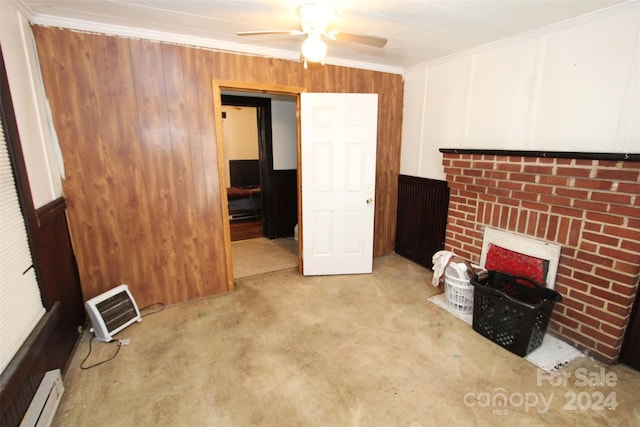 living room featuring light carpet, crown molding, ceiling fan, a fireplace, and baseboard heating