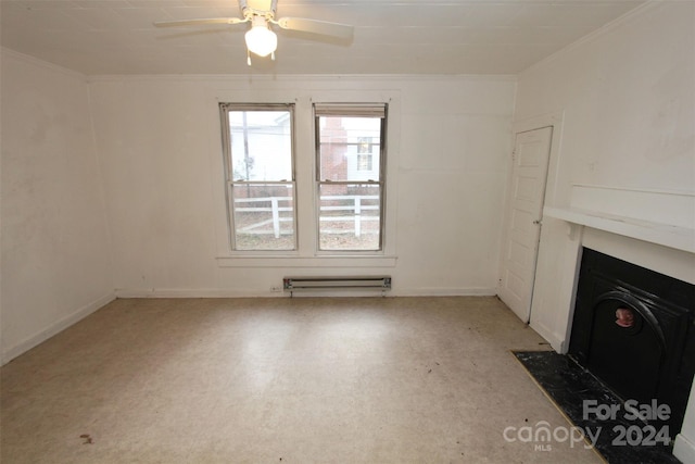 unfurnished living room featuring ceiling fan, ornamental molding, and a baseboard heating unit