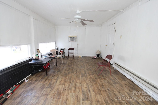 miscellaneous room featuring dark wood-type flooring, an AC wall unit, ceiling fan, and a baseboard heating unit