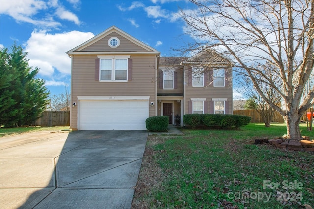 view of front of home with a front lawn and a garage