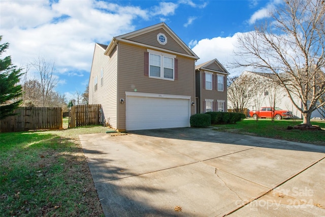 view of front of property featuring a garage and a front yard