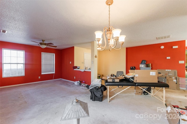 interior space with a textured ceiling and ceiling fan with notable chandelier