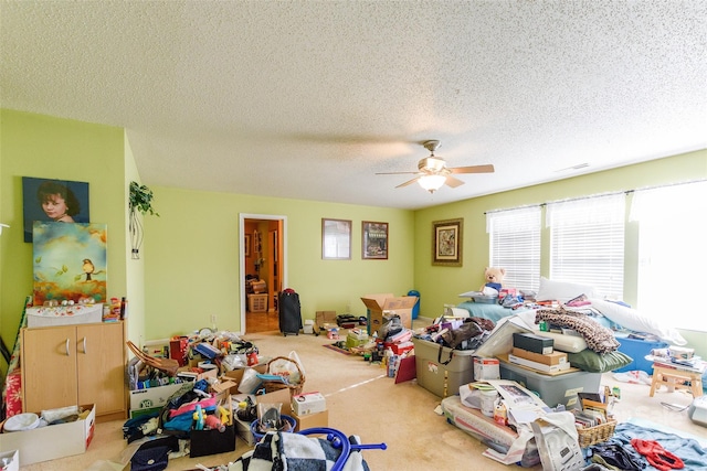 interior space featuring a textured ceiling, carpet floors, and ceiling fan