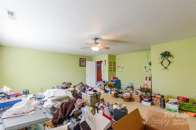 interior space with ceiling fan and a textured ceiling