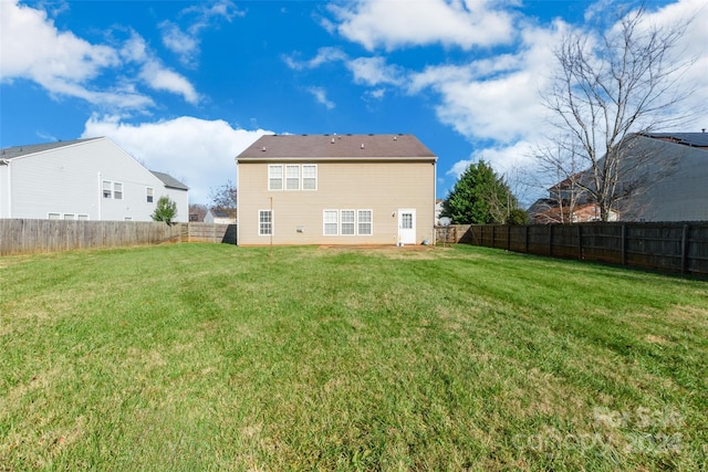 back of house with a yard