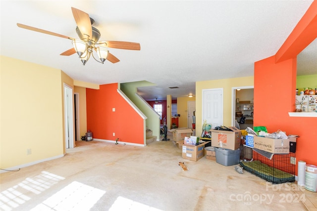 carpeted living room with a textured ceiling and ceiling fan