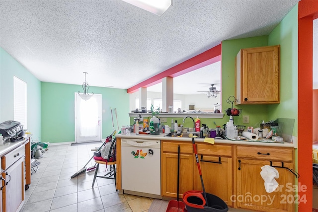 kitchen featuring ceiling fan, sink, white dishwasher, a textured ceiling, and decorative light fixtures