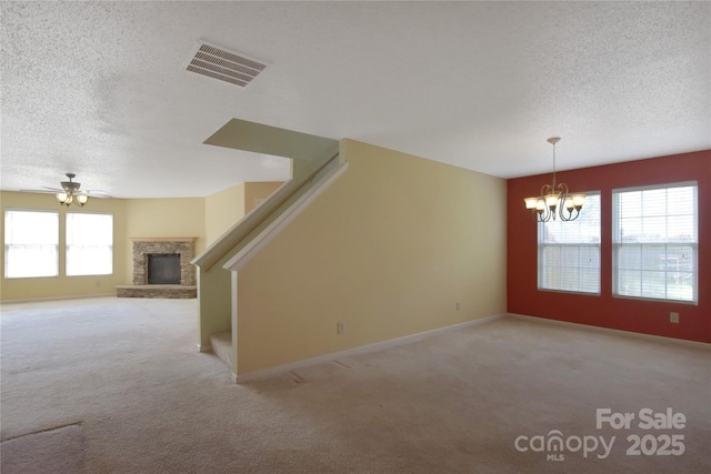1114 Fenwick Ct, Clover, SC 29710 - unfurnished living room featuring carpet flooring, a textured ceiling, visible vents, and a fireplace