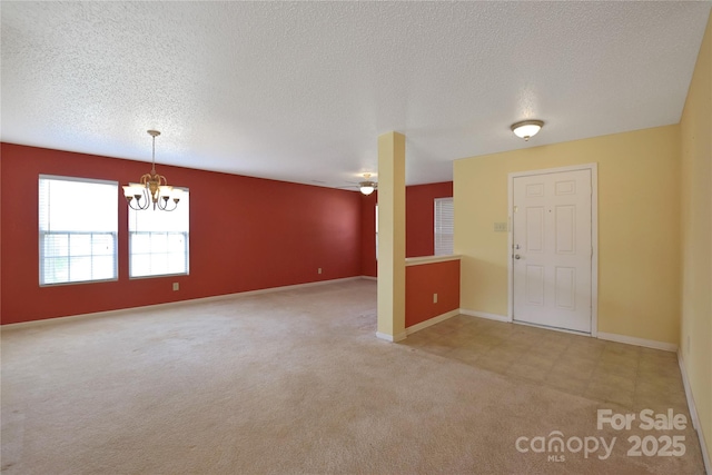 1114 Fenwick Ct, Clover, SC 29710 - unfurnished room featuring an inviting chandelier, baseboards, light carpet, and a textured ceiling