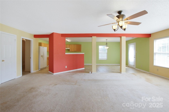 1114 Fenwick Ct, Clover, SC 29710 - unfurnished living room featuring baseboards, a ceiling fan, light colored carpet, and a wealth of natural light