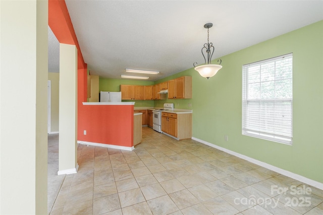 1114 Fenwick Ct, Clover, SC 29710 - kitchen with decorative light fixtures, light countertops, a peninsula, under cabinet range hood, and white appliances