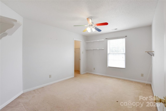 1114 Fenwick Ct, Clover, SC 29710 - unfurnished bedroom featuring carpet flooring, a walk in closet, a ceiling fan, baseboards, and visible vents