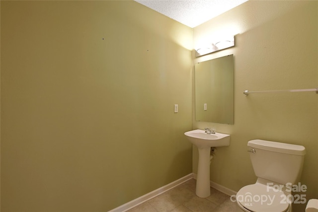 1114 Fenwick Ct, Clover, SC 29710 - bathroom with a sink, baseboards, tile patterned flooring, and toilet