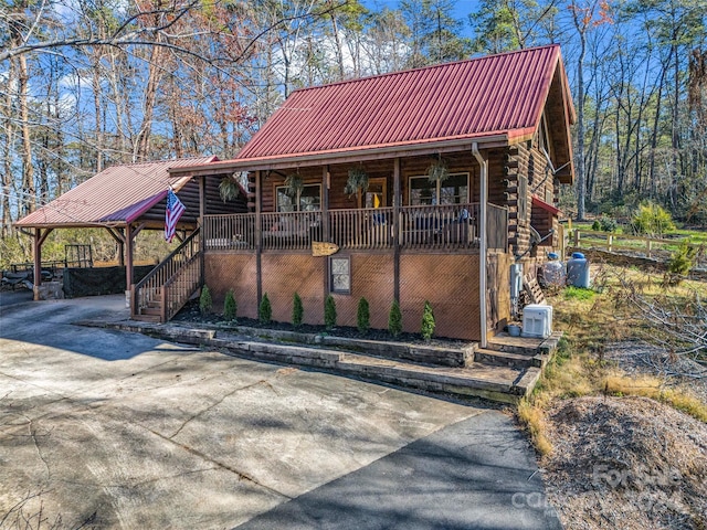 log cabin featuring a porch