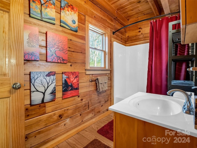 bathroom featuring wood walls, hardwood / wood-style floors, vanity, and wooden ceiling