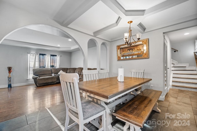 dining room with hardwood / wood-style floors and an inviting chandelier