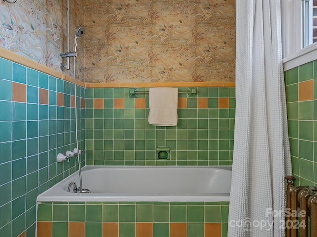 bathroom featuring radiator and shower / bath combination with curtain