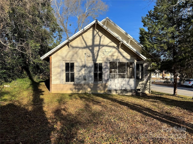 view of side of home with a yard