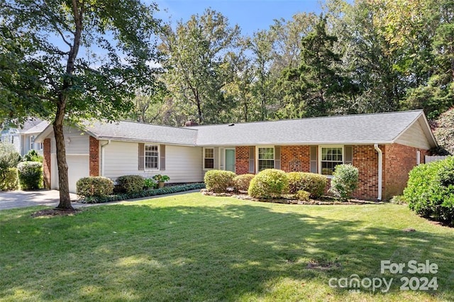 ranch-style house with a garage and a front yard