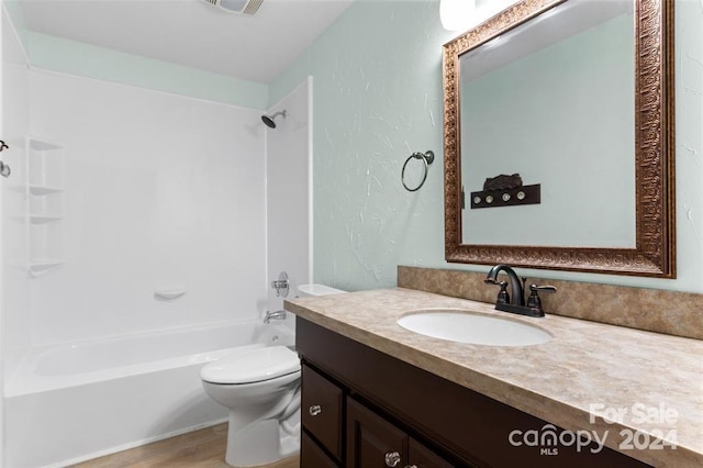 full bathroom featuring vanity, toilet, wood-type flooring, and shower / tub combination