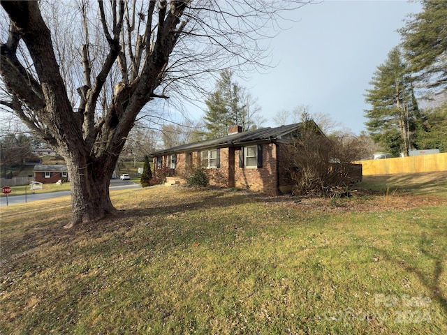 view of property exterior with a yard