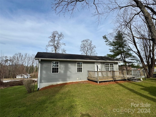 back of house featuring a yard and a wooden deck