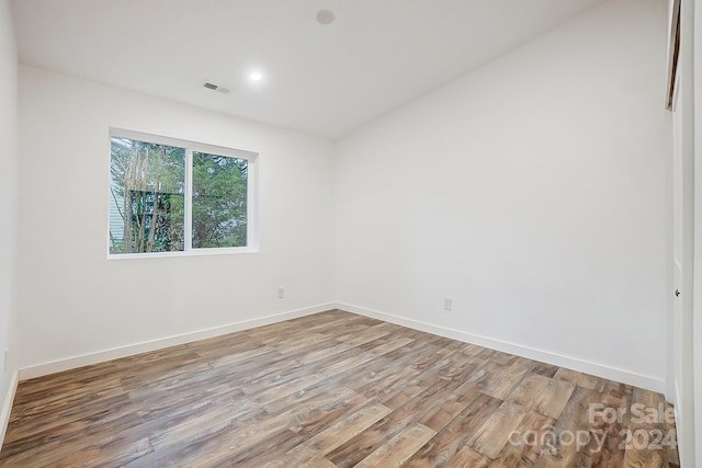 empty room with light hardwood / wood-style flooring