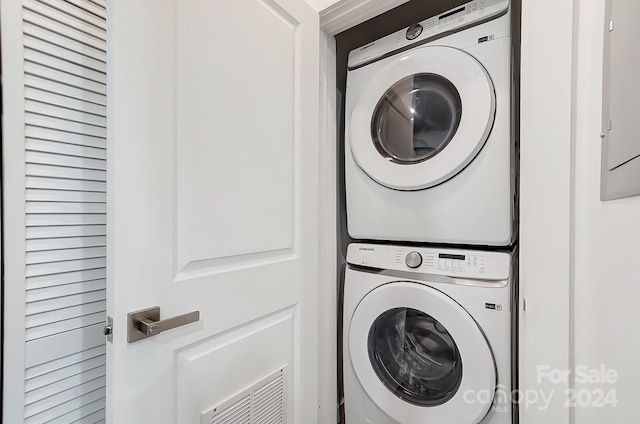 laundry room featuring stacked washer / drying machine