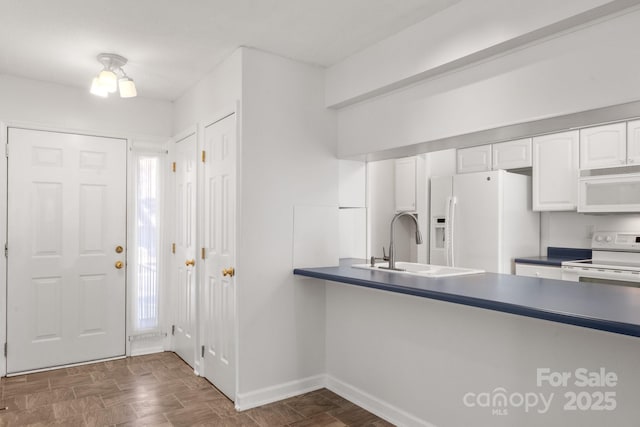 kitchen with white cabinetry, white appliances, and sink