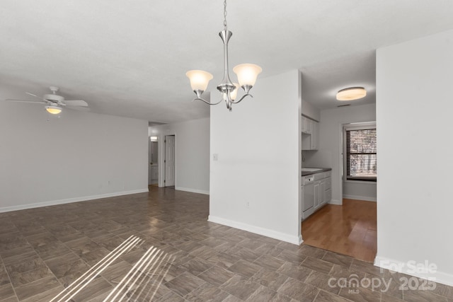 interior space with ceiling fan with notable chandelier