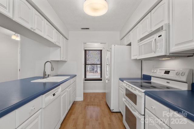 kitchen with light wood-type flooring, white appliances, a textured ceiling, sink, and white cabinets